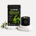 AITAPE Performance Infused Kinesiology Tape black packaging and a matching black tape roll with logo on a white display stand.
